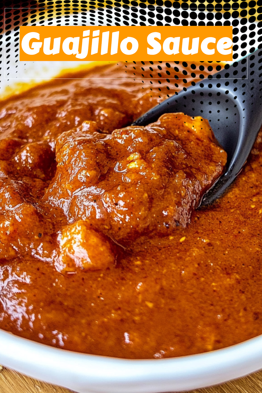 Image of delicious homemade guajillo sauce in a bowl with dried peppers scattered around